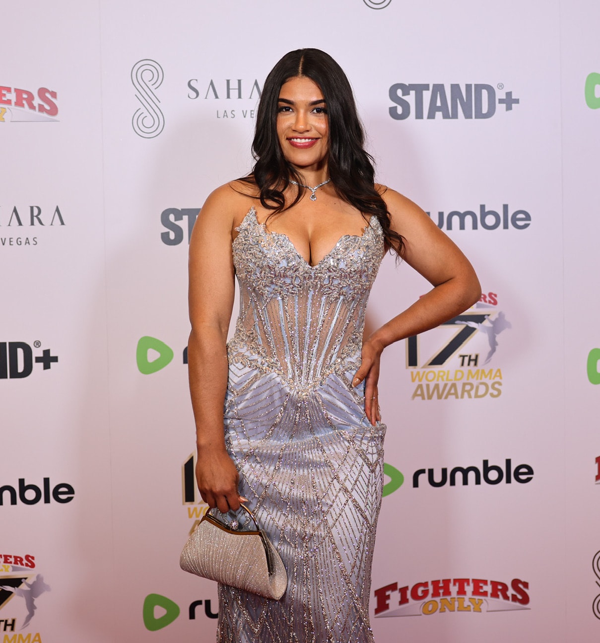 Woman in silver beaded gown on the red carpet at the MMA Awards